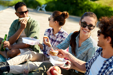 Image showing friends hiking and having picnic on lake pier