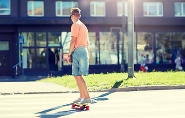 Image showing teenage boy on skateboard crossing city crosswalk