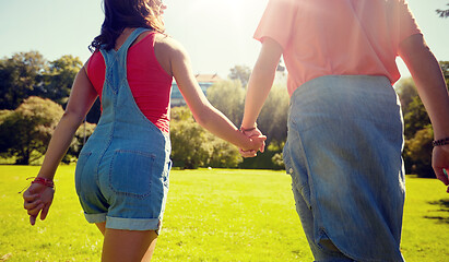 Image showing happy teenage couple walking at summer park