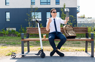 Image showing businessman recording video blog by smartphone