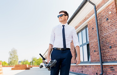 Image showing businessman with folding scooter on rooftop