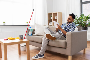 Image showing indian man with to do list after home cleaning