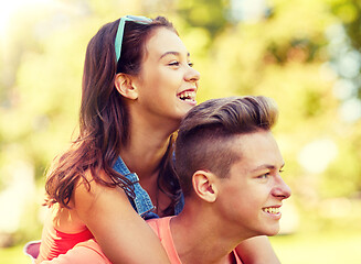 Image showing happy teenage couple having fun at summer park