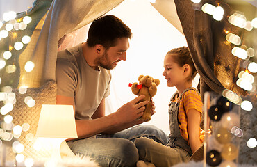 Image showing happy family playing with toy in kids tent at home