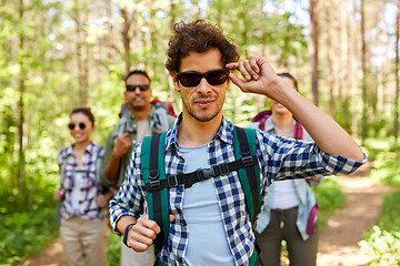 Image showing friends with backpacks on hike in forest