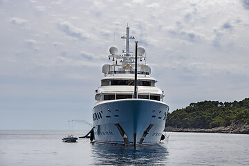 Image showing Blue luxury motor yacht, anchored in the calm sea