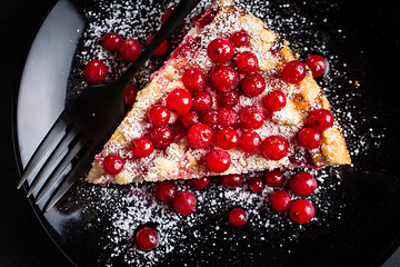 Image showing Homemade vegan red currant cake on black