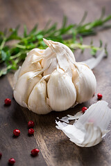 Image showing Garlic with red pepper and herbs on wooden background