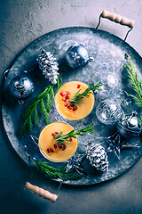 Image showing Traditional egg liqueur or eggnog with cinnamon, pomegranate and rosemary for Christmas