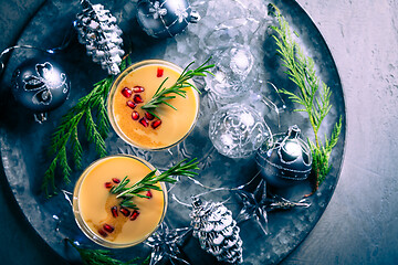 Image showing Traditional egg liqueur or eggnog with cinnamon, pomegranate and rosemary for Christmas