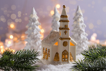 Image showing Small church with candles and white trees as snowy landscape