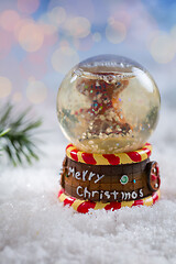 Image showing Snowball on snow with blurry background. Symbol of winter and Christmas.