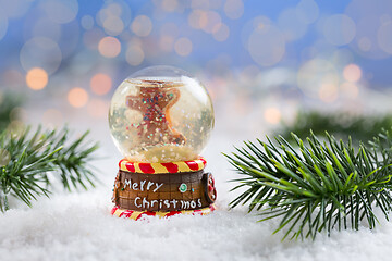 Image showing Snowball on snow with blurry background. Symbol of winter and Christmas.