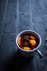 Image showing Spicy mulled wine with orange, cinnamon and anise in mug