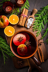 Image showing Spicy mulled wine with orange, apple, cinnamon and anise in pot