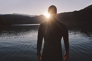 Image showing triathlon athlete starting swimming training on lake