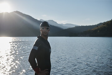 Image showing triathlon athlete starting swimming training on lake