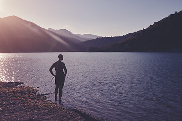 Image showing triathlon athlete starting swimming training on lake