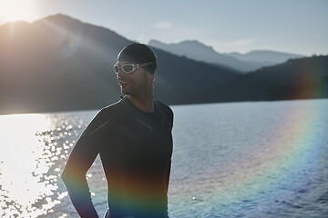 Image showing triathlon athlete starting swimming training on lake