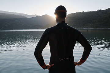 Image showing triathlon athlete starting swimming training on lake