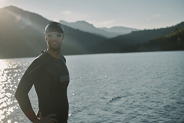 Image showing triathlon athlete starting swimming training on lake