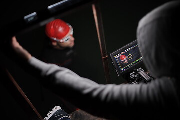 Image showing videographer taking action shot of triathlon swimming athlete at night