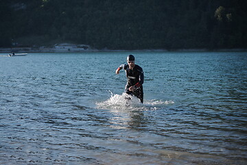 Image showing triathlon athlete starting swimming training on lake