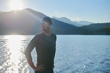 Image showing triathlon athlete starting swimming training on lake