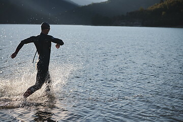 Image showing triathlon athlete starting swimming training on lake