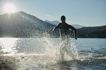 Image showing triathlon athlete starting swimming training on lake