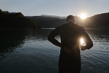 Image showing triathlon athlete starting swimming training on lake