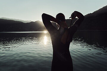 Image showing triathlon athlete starting swimming training on lake