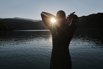 Image showing triathlon athlete starting swimming training on lake