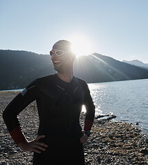 Image showing triathlon athlete starting swimming training on lake