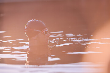 Image showing triathlete swimmer having a break during hard training