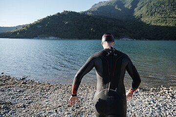 Image showing triathlon athlete starting swimming training on lake