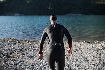 Image showing triathlon athlete starting swimming training on lake