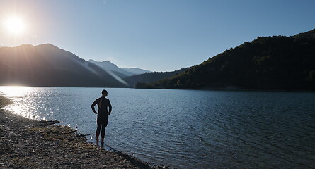 Image showing triathlon athlete starting swimming training on lake