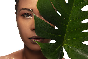 Image showing Portrait of beautiful african-american woman isolated on white studio background. Beauty, fashion, skincare, cosmetics concept.