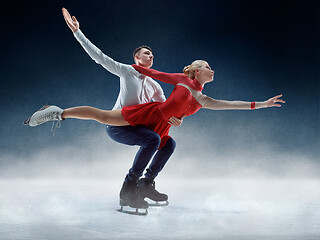 Image showing Professional man and woman figure skaters performing on ice show