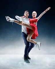 Image showing Professional man and woman figure skaters performing on ice show