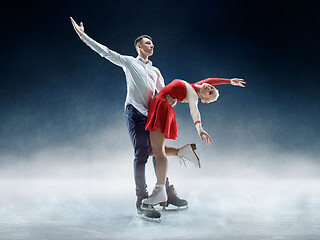 Image showing Professional man and woman figure skaters performing on ice show