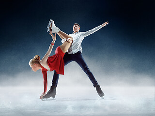 Image showing Professional man and woman figure skaters performing on ice show