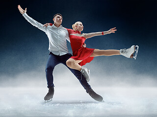 Image showing Professional man and woman figure skaters performing on ice show