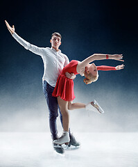 Image showing Professional man and woman figure skaters performing on ice show