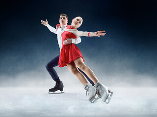 Image showing Professional man and woman figure skaters performing on ice show