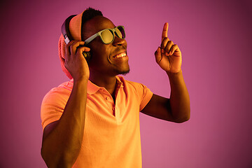 Image showing The young handsome hipster man listening music with headphones