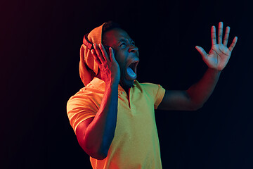 Image showing The young handsome hipster man listening music with headphones