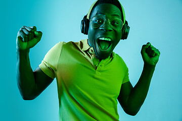 Image showing The young handsome hipster man listening music with headphones