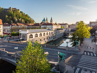 Image showing Aerial drone panoramic view of Ljubljana medieval city center, capital of Slovenia in warm afternoon sun. Empty streets during corona virus pandemic social distancing measures